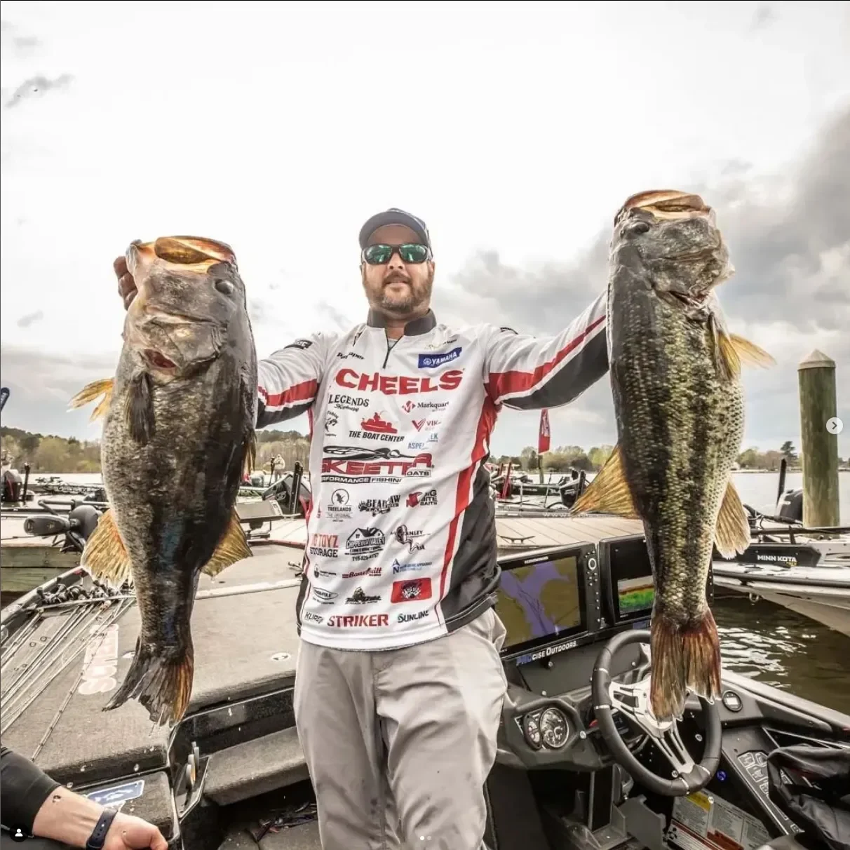 Image of Bass Master Elite Pat Schlapper holding 2 fish, showcasing the power of Lynac's lithium batteries.